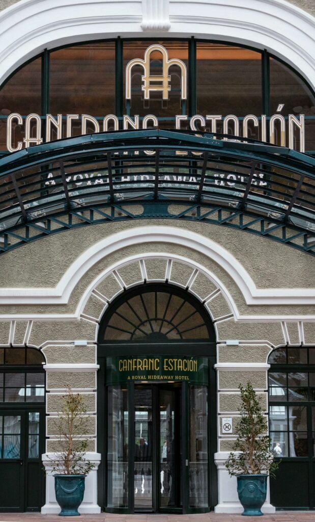 Front view of the elegant entrance of Canfranc Estación Hotel, featuring classic architecture.