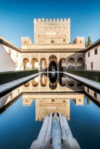 Serene reflection of the Alhambra's courtyard in Granada, Spain.